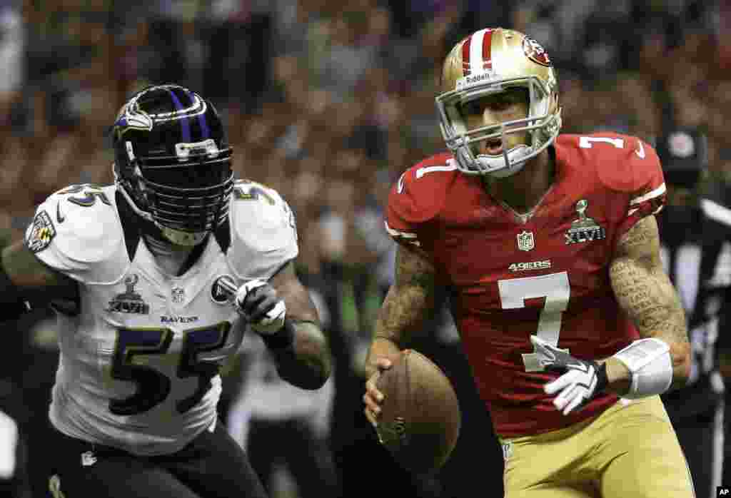 San Francisco 49ers quarterback Colin Kaepernick (7) carries the ball past Baltimore Ravens linebacker Terrell Suggs (55) during the first half of the NFL Super Bowl XLVII football game, Sunday, Feb. 3, 2013, in New Orleans.